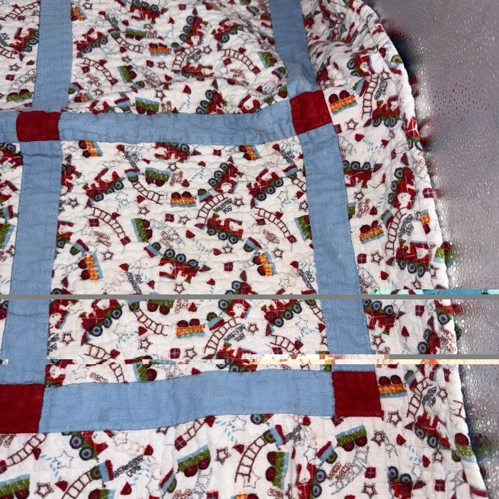Vtg Baby Quilt Of Trains Print bordered by blue sashing and red cornerstones