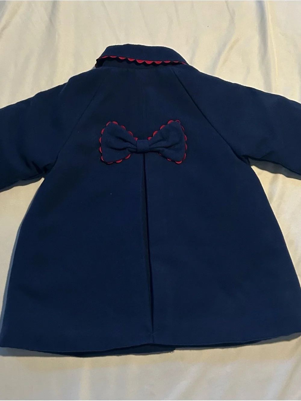 Little Me Navy Pea Coat with Red Scallop Trim and Bow.