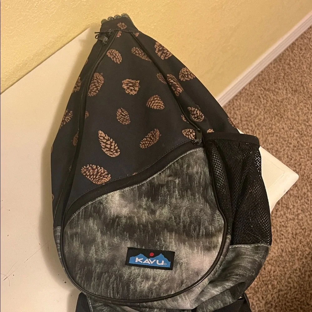 Kavu Pinecone Print Sling Backpack in Black and Brown