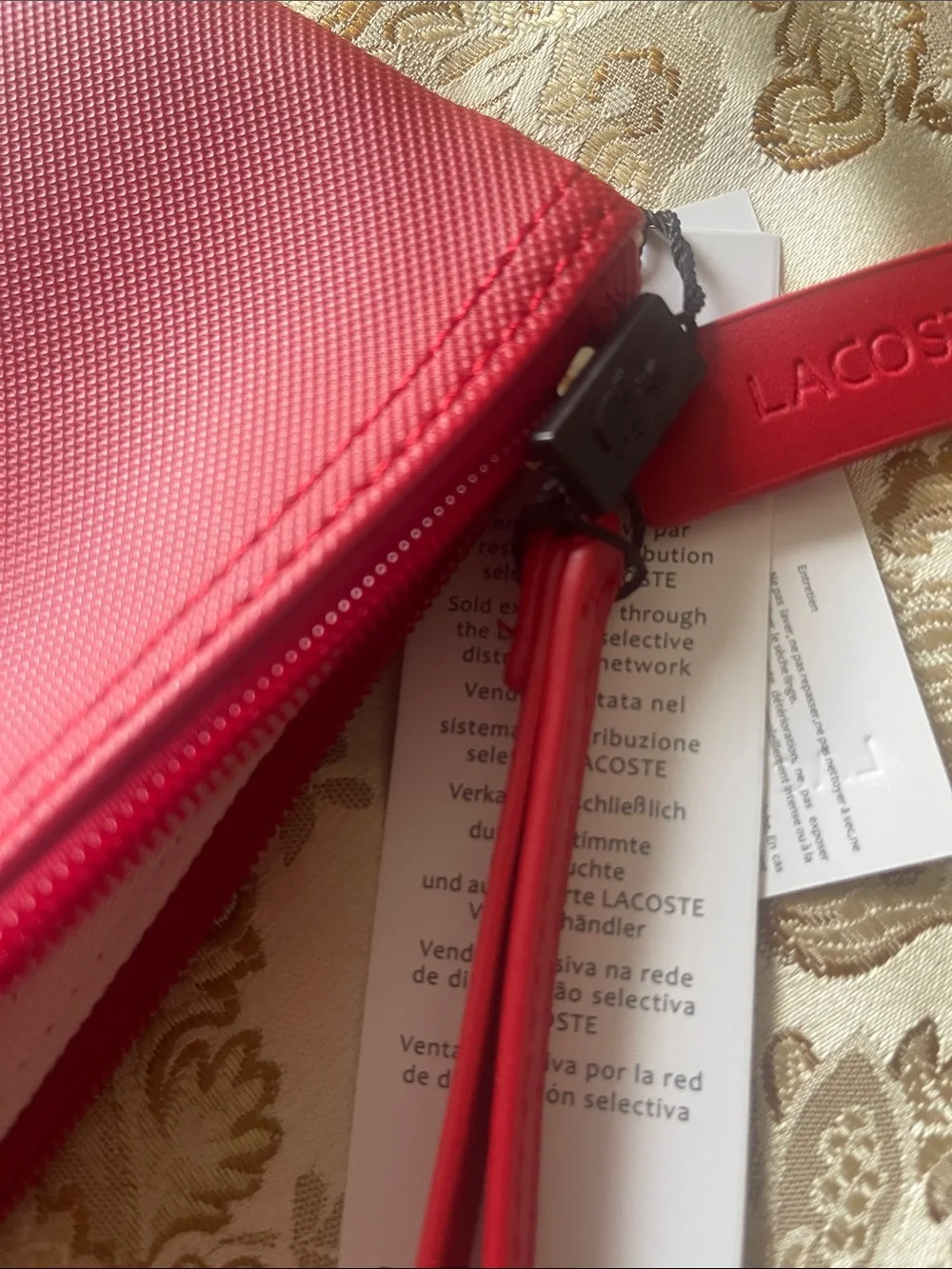 Lacoste compact wristlet