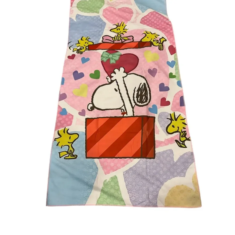 Snoopy peanuts come out of a present beach towel