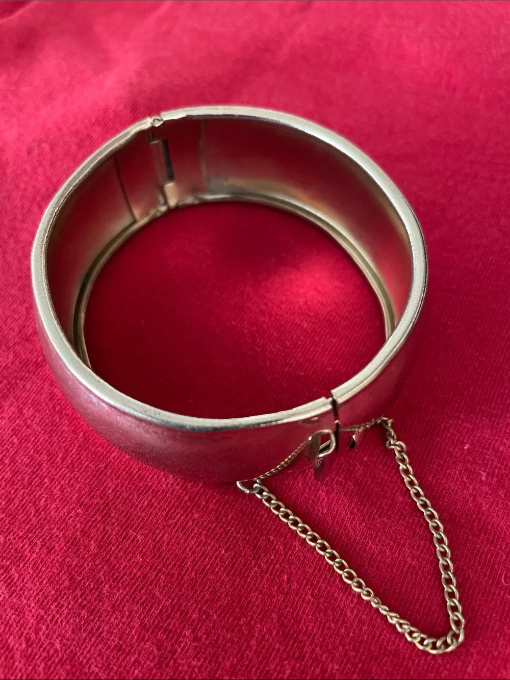 Polished Silver-Tone Hinged Bangle Bracelet with Safety Chain
