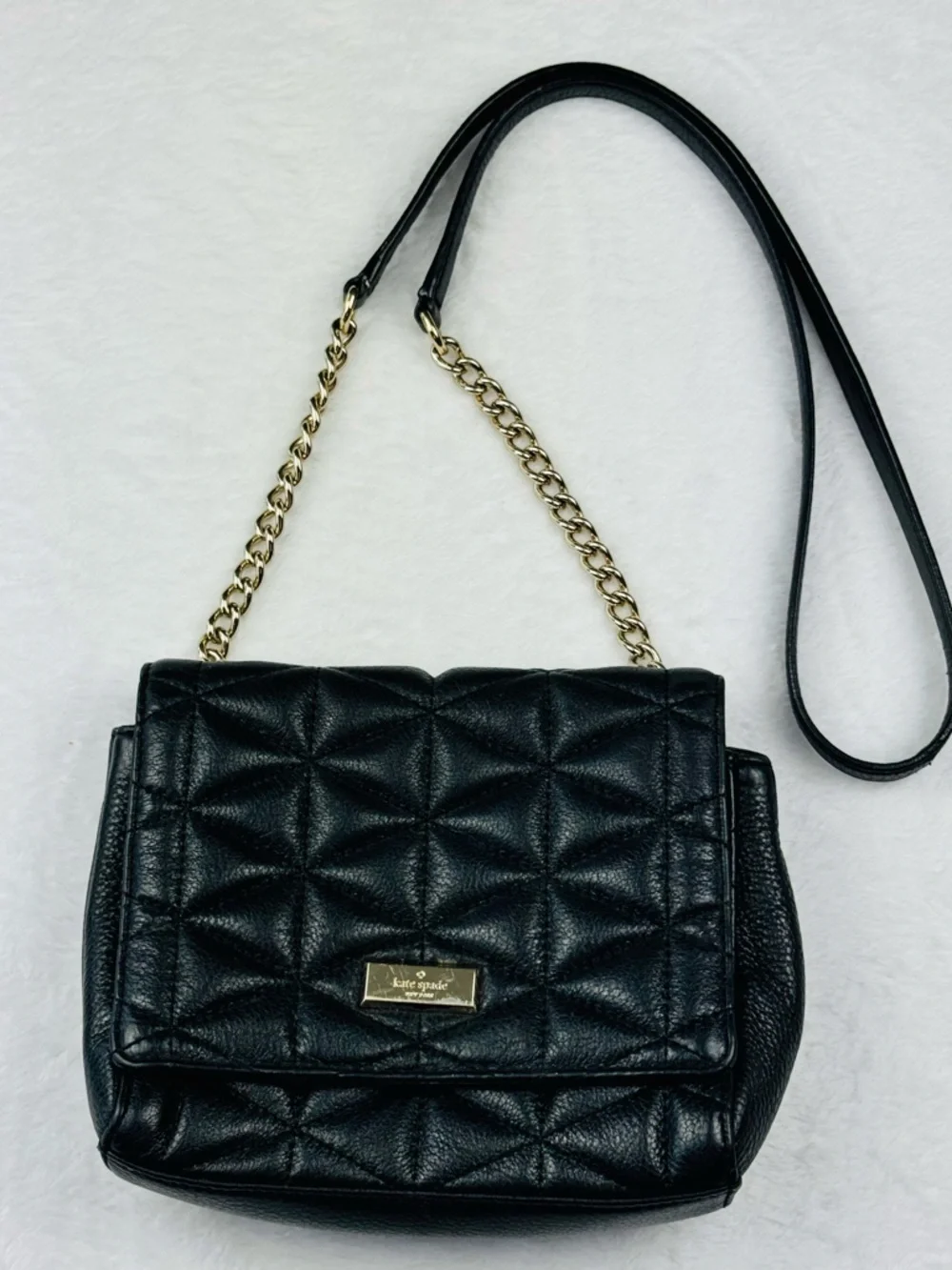 Kate Spade Quilted Black Leather Purse with Gold Chain and Metal Accents.