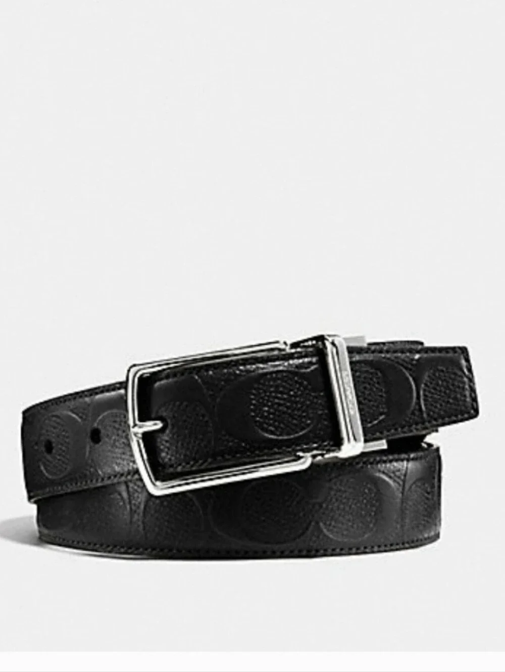 Black leather Coach belt. Reversible embossed Coach signature logo on one side.